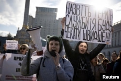 Protesters hold placards during a demonstration in Kyiv, Ukraine, on Oct. 27, 2023, calling for legislation regulating the length of active military duty and the frequency of soldiers' rotation.