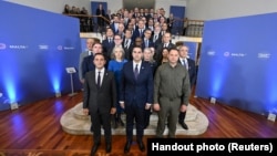 Delegates pose for a photograph at the weekend meeting organized by Ukraine to discuss its peace formula for ending the war with Russia, in St Julian's, Malta, Oct. 28, 2023.