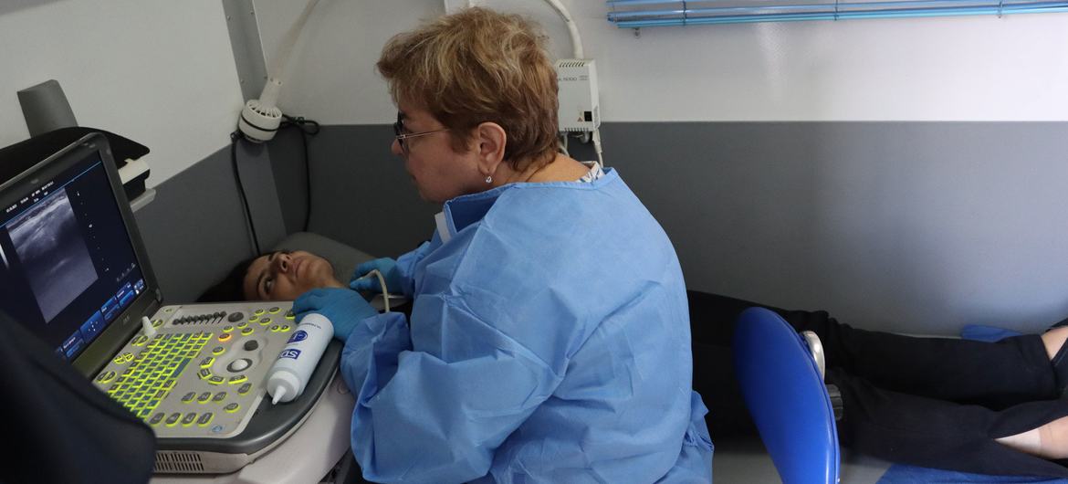 An IOM doctor examines a patient at the newly established mobile health clinic in Goris, Armenia.