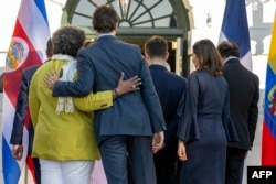 Canadian Prime Minister Justin Trudeau embraces Barbados Prime Minister Mia Mottley at the White House in Washington on Nov. 3, 2023, during the inaugural Americas Partnership for Economic Prosperity Leaders’ Summit.