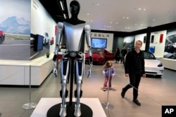 A nonworking marketing model of Tesla Inc.'s proposed Optimus humanoid robot is on display at the Westfield Garden State Plaza in Paramus, N.J., Nov. 2, 2023.