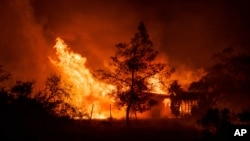 A structure is engulfed in flames as a wildfire called the Highland Fire burns in Aguanga, Calif., Oct. 30, 2023.