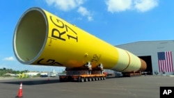 FILE - A huge foundation for an Orsted offshore wind turbine, called a monopile, sits atop wheeled movers in Paulsboro, NJ, July 6, 2023.