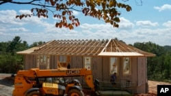 Workers build a home Sept. 19, 2023, in Marshall, N.C. Climate change is increasing billion-dollar disasters, many of them from intensifying hurricanes.