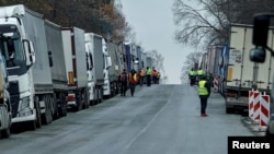 FILE - Ukrainian trucks are parked near the Poland-Ukraine border, near the village of Korczowa, Poland, Nov. 19, 2023.