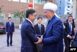 Imam of Yanghang Mosque Abdureqip Tumulniyaz, right, greets Pakistan's caretaker Prime Minister Anwaar-ul-Haq Kakar at Yanghang mosque in Urumqi, in China's Xinjiang province, in this Oct. 20, 2023, photo released by Pakistan's Prime Minister Office.