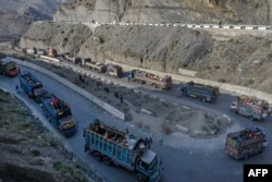 FILE - Trucks transporting Afghan refugees with their belongings are seen along a road towards the Pakistan-Afghanistan Torkham border, following Pakistan's government decision to expel people illegally staying in the country, Nov. 3, 2023.