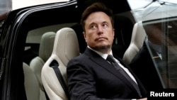 FILE - Tesla Chief Executive Officer Elon Musk gets in a Tesla car as he leaves a hotel in Beijing, China, May 31, 2023.