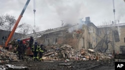 In this photo provided by Ihor Moroz, Head of the Donetsk Regional Military Administration, rescuers work at the scene of a building destroyed by shelling, in Novohorodivka, Donetsk region, Ukraine, Nov. 30, 2023.