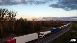 Trucks queue on a motorway as Polish transport company owners with their vehicles block access to the Polish-Ukrainian border crossing in Dorohusk, Poland on Nov. 6, 2023 to protest against 'unfair' competition.
