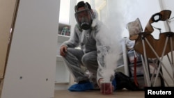 FILE - Sacha Krief, manager of Hygiene Premium pest control specialized store and extermination service, treats an apartment against bedbugs in Paris on Oct. 6, 2023.