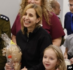 FILE - Danielle Aloni laughs next to her daughter, Emilia, 5, as they meet family members at the Schneider Children's Medical Center in Israel on Nov. 25, 2023. The two were among hostages held by U.S.-designated terror group Hamas in Gaza.