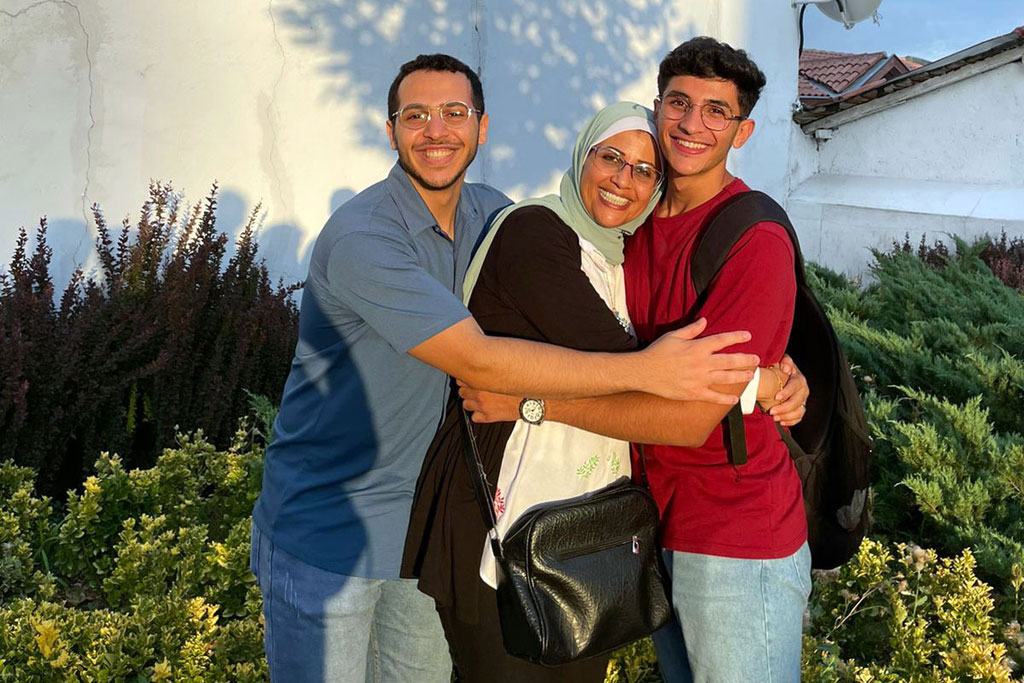 Hala with her son (on the right) and nephew, both attending university in Turkey, during her visit to them in 2022.