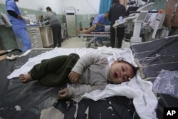 A Palestinian child wounded in the Israeli bombardment of the Gaza Strip is brought to a hospital in Rafah, Dec. 12, 2023.