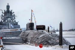 Russian sailors stand on the deck of the new nuclear submarine Emperor Alexander III as President Vladimir Putin attends a flag-raising ceremony for that and a second sub at the Sevmash shipyard in Severodvinsk, Dec. 11, 2023.