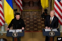 President Joe Biden and Ukrainian President Volodymyr Zelenskyy hold a news conference in the Indian Treaty Room in the Eisenhower Executive Office Building on the White House Campus, Dec. 12, 2023, in Washington.