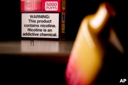 FILE - A health warning is seen on the packaging of a disposable vaping pod device in Washington , June 26, 2023.