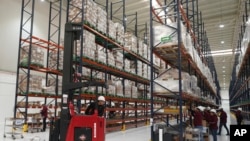 Workers unpack medications at a 'mega-pharmacy' warehouse in Huehuetoca, Mexico, Dec. 29, 2023.
