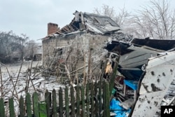 A view of private houses damaged by a Russian missile attack in Novomoskovsk, near Kryvyi Rih, Ukraine, Jan. 8, 2024. (Ukrainian Emergency Service via AP)