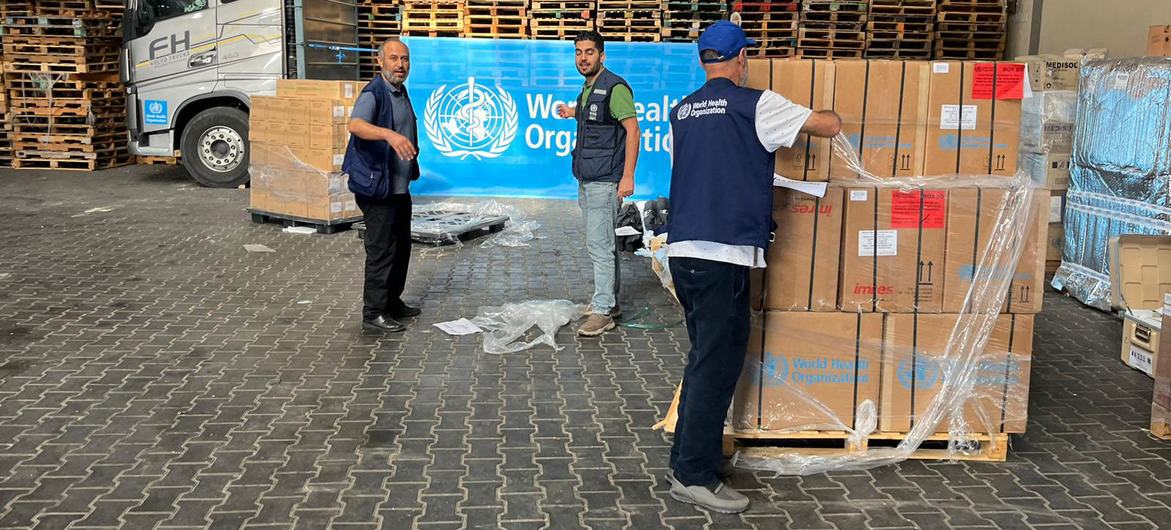Medical supplies organized by WHO are unloaded in a warehouse in Gaza.