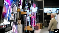 FILE - A customer browses televisions at a Best Buy store in Charlotte, North Carolina, Nov. 24, 2023.