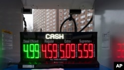 A pump at a Mobil gas station display prices in New York, Jan. 19, 2024.