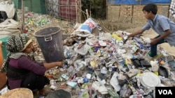 A Rohingya ragpicker woman and boy at work somewhere in the north Indian state of Haryana. Most Rohingya refugees do menial jobs for a living in India. (Zafor Alom/VOA)