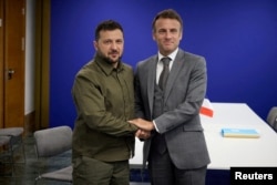 FILE - Ukraine's President Volodymyr Zelenskyy and French President Emmanuel Macron are pictured at the European Political Community Summit in Granada, Spain, Oct. 5, 2023. Their nations are to sign a bilateral security agreement Feb. 16, 2024, in Paris.