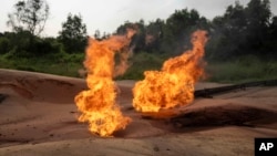 FILE - A burning flare is visible at an oil extraction area located in Moanda, Democratic Republic of the Congo, Dec. 23, 2023.