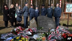 British soldiers pay tribute to Allied POWs who tunneled out of a German camp in WWII in an ingenious act of defiance known as the 'Great Escape,' in Zagan, Poland, March 24, 2024.