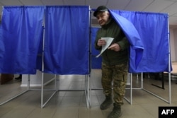 People vote in Russia's presidential election in the Russian-controlled area of the Donetsk region of Ukraine, March 15, 2024.