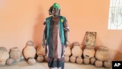 FILE - Mariama Sonko poses in the seed hut of her agro-ecological training center in the Casamance village of Niaguis, Senegal, March 7, 2024.