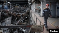 A worker walks at a thermal power plant damaged by a recent Russian missile strike, amid Russia's attack on Ukraine, in an undisclosed location of Ukraine, April 8, 2024.