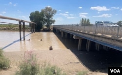 Children enjoy a hot day in Kegeyli, Karakalpakstan, which depends on the Amu Darya River as a water source, July 22, 2023.