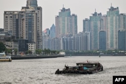 A boat sails across the Huangpu river in Shanghai on May 7, 2024.