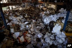 Burnt books are seen in a damaged workshop of Ukraine's largest printing house ruined in Thursday deadly Russian missile attack that killed seven civilians in Kharkiv, Ukraine, May 24, 2024.