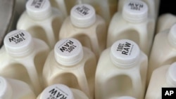 Bottles of raw milk are displayed for sale at a store in Temecula, Calif., on May 8, 2024.
