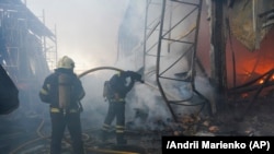 Firefighters put out a fire after two guided bombs hit a large construction supplies store in Kharkiv, Ukraine, May, 25, 2024.