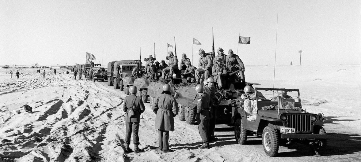 A UNEF motorised column flying the UN flag wait in January 1957 for the Israelis to evacuate El Arish to move into that city. (file)