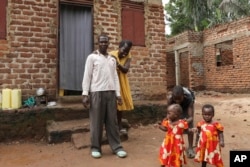 Barbara Nabulo who lives with sickle cell disease jokes with her husband at Busamaga-Mutukula village in Mbale, Uganda, April 25, 2024.