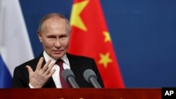 FILE - Russian President Vladimir Putin gestures as he talks with students of the Harbin Institute of Technology in Harbin, northeastern China's Heilongjiang Province, May 17, 2024.