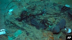 FILE - This 2004 photo provided by the Institute for Exploration, Center for Archaeological Oceanography/University of Rhode Island/NOAA Office of Ocean Exploration, shows the remains of a coat and boots on the sea bed near the Titanic's stern.