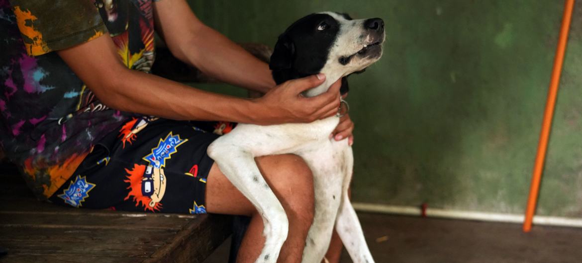 Carlo at home with his dog Butchokoy.