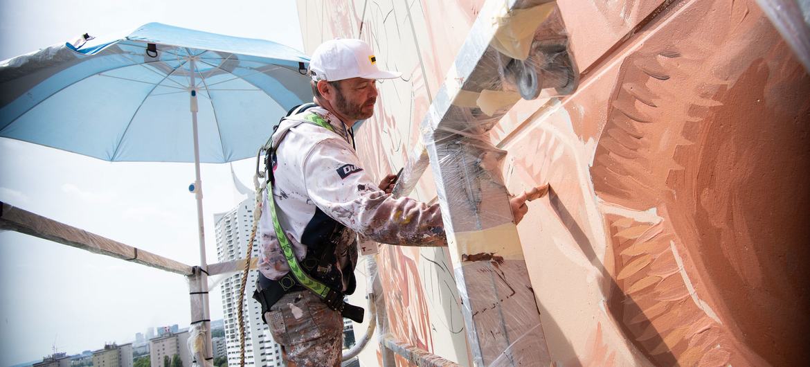 ‘Fragility of peace’ depicted in giant new mural on UN tower in Vienna