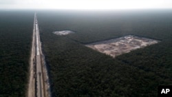 A line of the Mayan Train is built using material dug out from the nearby tropical forest near Playa del Carmen, Mexico, March 1, 2024. When it's completed, the high-speed Maya Train will wind around Mexico's southern Yucatan peninsula.