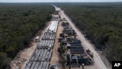 Workers build a Maya Train railway track near Playa del Carmen, Mexico, March 10, 2024.