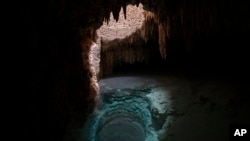 ight shines through a hole made by massive metal drills to introduce a steel pillar filled with concrete that will be used to support a part of the Maya Train track, inside the Aktun Tuyul cave system on the outskirts of Playa del Carmen, Mexico, March 3, 2024.