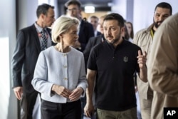 Ursula Von der Leyen, president of the European Commission, left, walks with Ukrainian President Volodymyr Zelenskyy at the Summit on Peace in Ukraine, at Buergenstock resort, Switzerland, June 16, 2024. (Michael Buholzer/Keystone via AP)