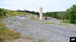 FILE - West Virginia University's Water Research Institute runs this facility where rare earth minerals are separated from acidic groundwater draining from an abandoned coal mine, June 25, 2024, in Mount Storm, W.Va.