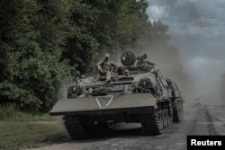 Ukrainian soldiers ride a military vehicle near the Russian border in the Sumy region, Ukraine, on Aug. 10, 2024.